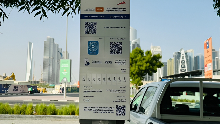 Parking sign indicating the different ways you can pay for parking in Dubai: by scanning a QR code, Apple Pay, Whatsapp, SMS. It also contains payment information