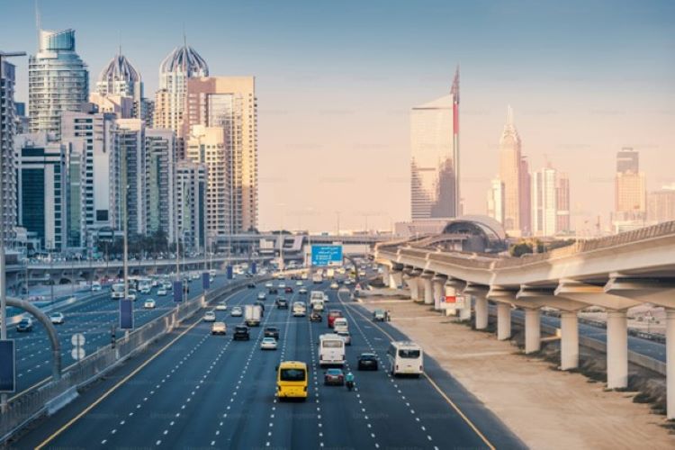 Aerial view of the famous Sheikh Zayed Road with car traffic and metro rails and numerous skyscrapers in Dubai Marina area