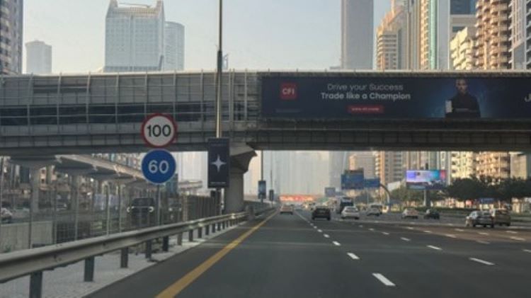 The view of Sheikh Zayed Road with a bridge over it and skyscrapers on either side.